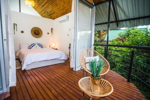 a bedroom with a bed on a wooden deck at Valhalla Nimaima Glamping in Nimaima