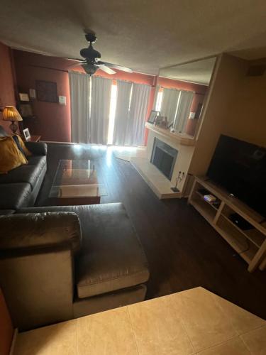 a living room with a couch and a television at Private Oasis Condo with River views across from Laughlin in Bullhead City