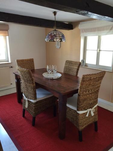 a dining room with a wooden table and chairs at Zweite Heimat Ferienwohnungen in Herdecke