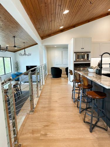 an open kitchen and dining room with a large island in a house at Newly Renovated 4B, 2.5 bath Lakefront home with South Grand Lake Views and dock in Vinita