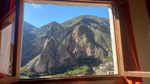 a window with a view of a mountain at Hospedaje Ale in Iruya