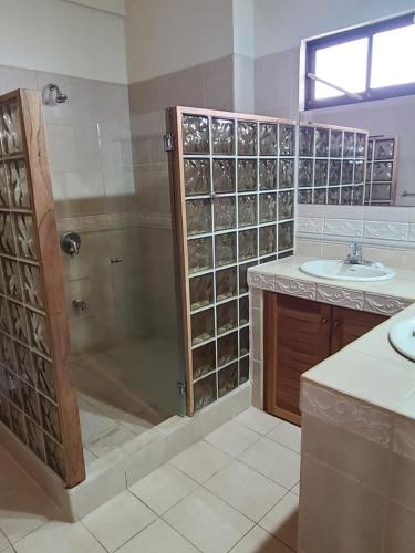 a bathroom with a shower and a sink at Hermosa Beach House in Playa Hermosa
