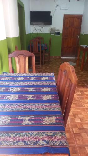 a dining room with a table and two chairs and a table at Hospedaje Ale in Iruya