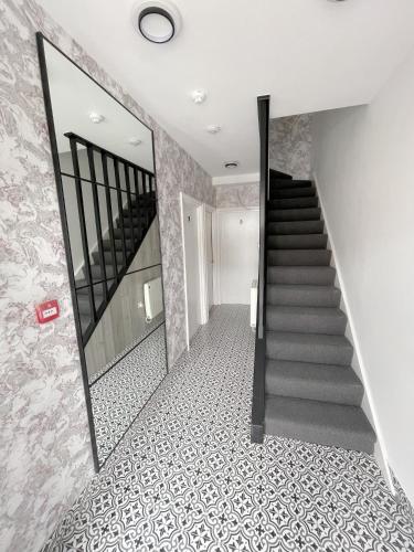a staircase in a house with a tile floor at Cosy Bright Studio Apartment Close to Wembley Stadium in London