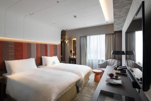 台北的住宿－台北亞都麗緻大飯店，酒店客房设有两张床和电视。