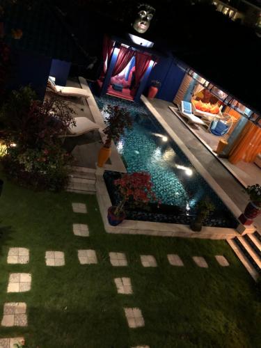 an overhead view of a swimming pool at night at Villa Majorelle Bali in Seminyak