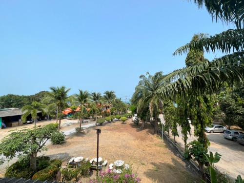 a view of a park with palm trees and a street at Baan Wang Bua in Ban Khok Kroat