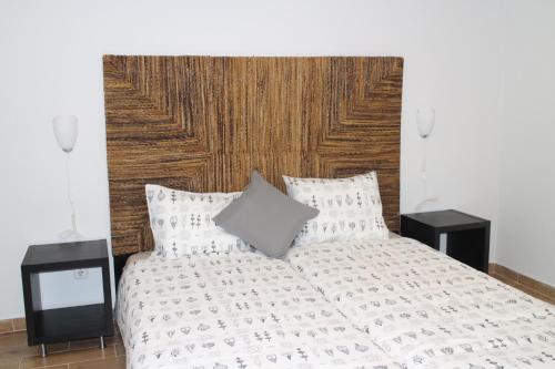 a bedroom with a white bed with two night stands at Rossio Studios in Lisbon