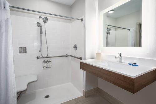 a bathroom with a sink and a toilet and a mirror at Holiday Inn Express & Suites Tucson, an IHG Hotel in Tucson
