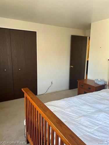 a bedroom with a wooden bed and a wooden dresser at Budget 3 bedrooms homestay in Northville
