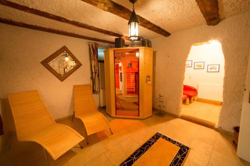 a living room with two chairs and a mirror at Frühstückspension Bachseitenhof in Radstadt