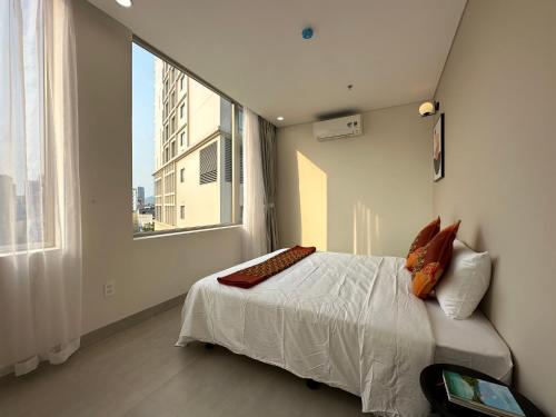 En eller flere senge i et værelse på Khe Suites Serviced Apartment - Han River