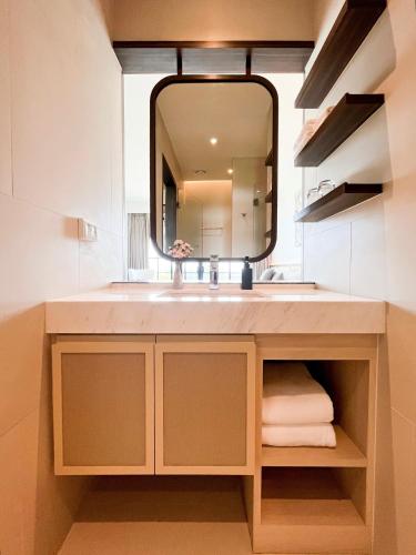 a bathroom with a sink and a mirror at Estella Khao Yai in Khao Yai