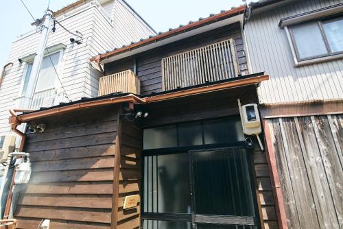 a house with a deck on the side of it at Nagomi TABI-NE in Kanazawa