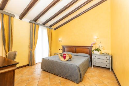 a bedroom with a bed with a stuffed animal on it at Hotel Arbatasar in Àrbatax