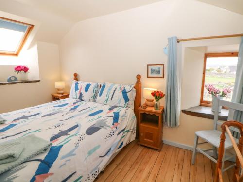 a bedroom with a bed and a window at The Old Bakery Barn in Bakewell