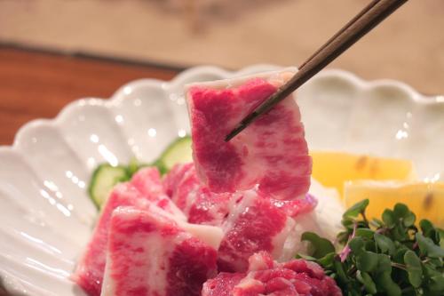 a plate of food with a piece of food on a stick at YamakawaZENZO in Oguni