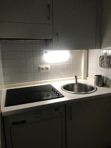 a kitchen with a sink and a stove top oven at Appartamento in centro a Mentone vicino alla spiaggia Parcheggio privato INCLUSO! in Menton