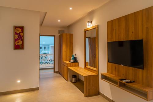 a living room with a flat screen tv on a wall at Tree of Life Vantara Resort & Spa in Udaipur