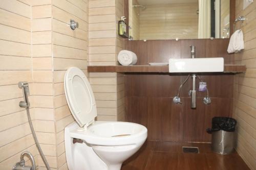 A bathroom at Kyriad Hotel Indore by OTHPL