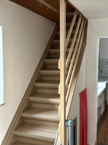 a staircase in a house with wooden rails at FERIENPARADIES AM KAMMERBERG - ein ganzes Haus für Sie alleine!!! in Weißenhorn