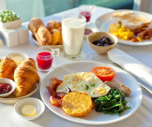 a table topped with plates of breakfast foods and drinks at Pokoje Pracownicze Gniezno in Gniezno