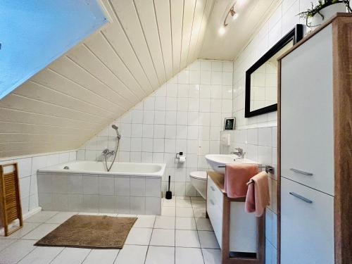 a bathroom with a sink and a bath tub at Pension Weiberwirtschaft in Pobershau in Pobershau