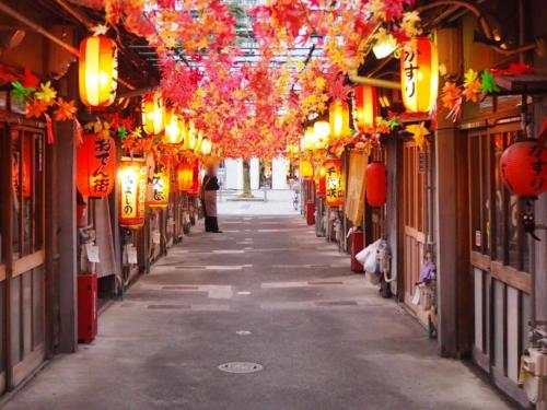 an alleyway with lanterns and lights in an asian street at Hotel Wing International Shizuoka in Shizuoka