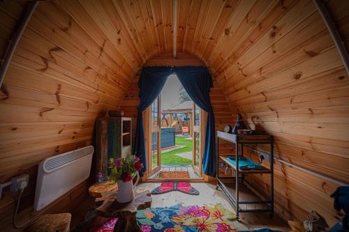 an inside view of a wooden cabin with a doorway at Bespoke Holiday Home With Private Pool And Hot Tub, Sleeps 8 Ref 34073P in Kings Lynn