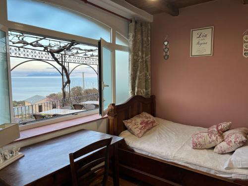 a bedroom with a bed and a large window at Casa di Babbo in Macinaggio