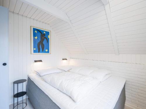 a large white bed in a white room at 6 person holiday home in Hvide Sande in Bjerregård