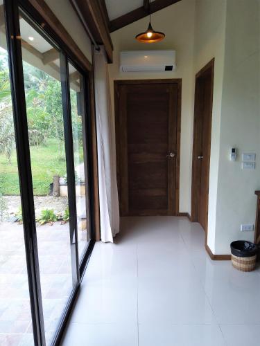 an empty room with a sliding glass door at Forest garden residence in Bilar