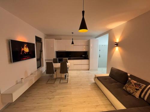 a living room with a couch and a dining room at Apartament cu 2 camere Giroc in Giroc