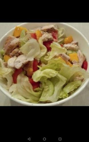 a white bowl of salad with meat and vegetables at Forest garden residence in Bilar