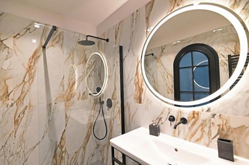 a bathroom with a sink and a mirror at Borelli Palace & Borelli Blue in Zadar
