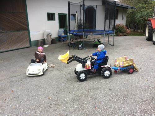 two toy children riding on toy cars and motorcycles at SportApartment Wabnig in Moosburg