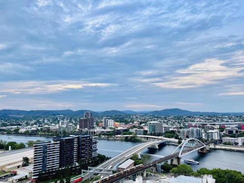 a city with a bridge over a river with buildings at CASSA BCT - River-View Apartments Managed by The Cassa in Brisbane