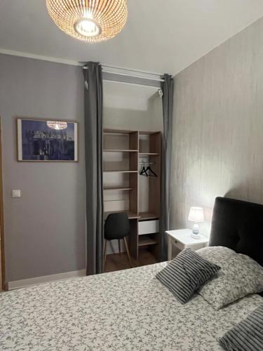 a bedroom with a bed and a chair and a closet at Vivez le Port de plaisance - Plage in Le Havre