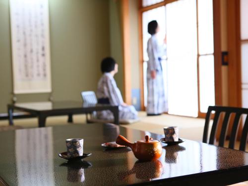 a table with a tea cup on top of it at Ogiwarakan in Chikuma