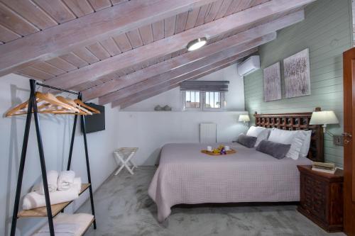 a bedroom with a bed and a wooden ceiling at Villa Splantzia - Heated pool - Garden in Chania