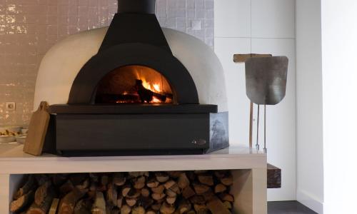 a brick oven with a fire inside of it at Octant Furnas in Furnas