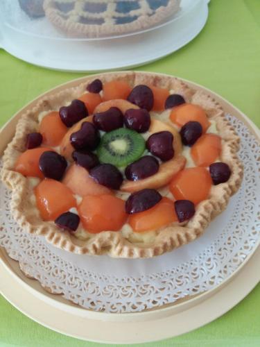 a fruit tart on a plate on a table at Ca'Mea in Villasimius