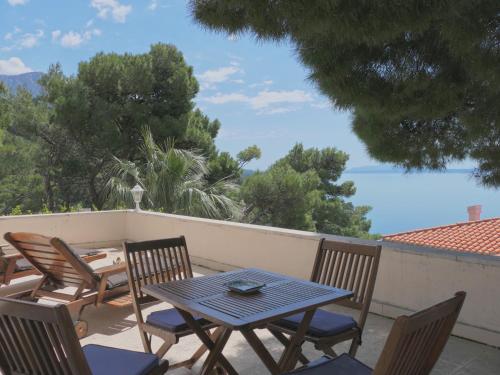 a patio with a table and chairs on a balcony at Villa Marina in Brela