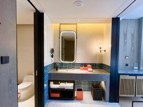 a bathroom with a sink and a toilet at Four Points by Sheraton Chongqing, Yongchuan in Yongchuan