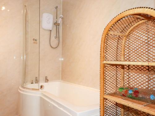 a bathroom with a shower and a bath tub with a shower at Trevow in Camborne