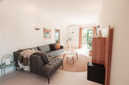 a living room with a couch and a table at Casa Velha Apartments - Adults friendly in Albufeira