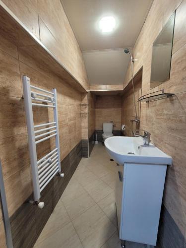 a bathroom with a sink and a toilet at Китанови- стаи за гости in Sliven