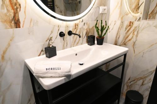 a bathroom with a white sink and a mirror at Borelli Palace & Borelli Blue in Zadar
