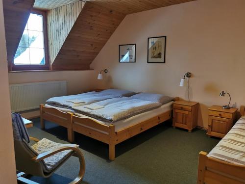 a bedroom with a bed and a chair in it at Privát Kováč in Vysoké Tatry