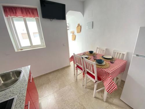 a kitchen with a table with a red and white table cloth at Conil Homes V Apartments in Conil de la Frontera
